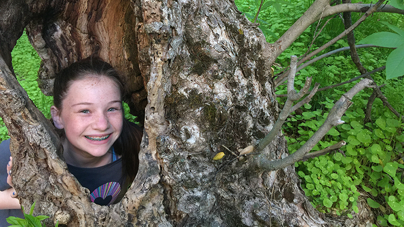 Natalie Bourn Playing In a Hollow Tree Trunk on Our Pinnacles National Park Family Vacation