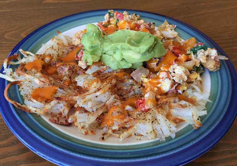 Waffled Hashbrowns with Vegetable Eggs, Buffalo Sauce, and Guacamole