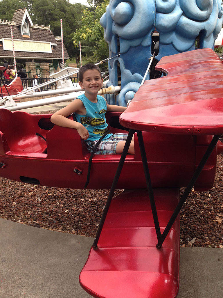Carter Riding the Red Baron Airplane Ride at Funderland