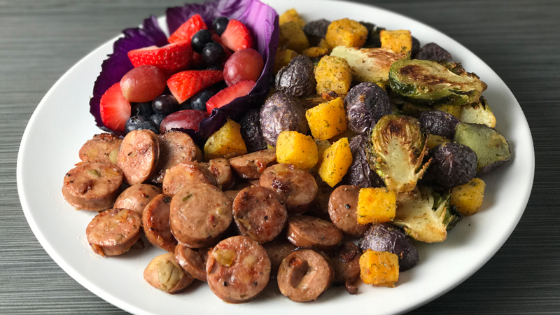Whole30 Dinner: Onion And Garlic Roasted Vegetables With Artichoke Garlic Sausages and Fresh Fruit