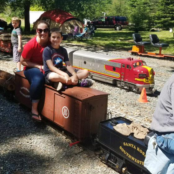 Jennifer and Carter Bourn Riding a Miniature Steam Engine at Hagen Park
