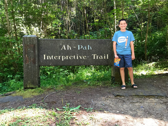 Carter Bourn standing at the Ah Pah Interpretive Trail Sign