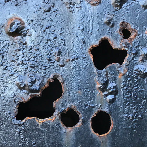 Rusted Holes in Metal Doors