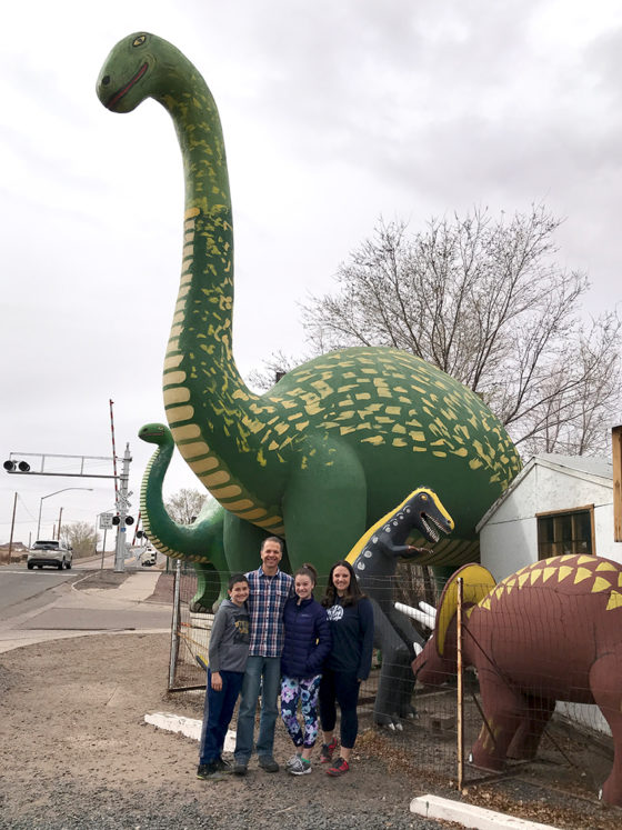 Bourn Family Posing With Dinosaurs at the Rainbow Rock Shop