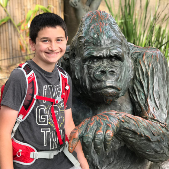 Carter Bourn Posing With a Gorilla Statue