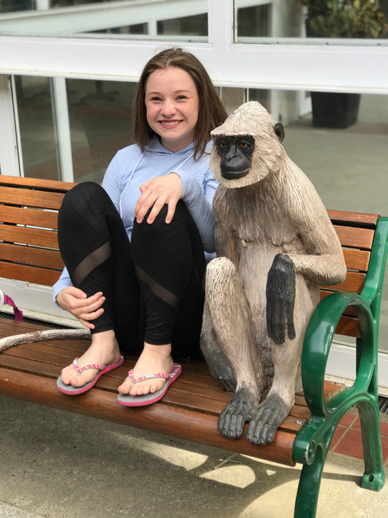 Natalie Posing With a Monkey Statue