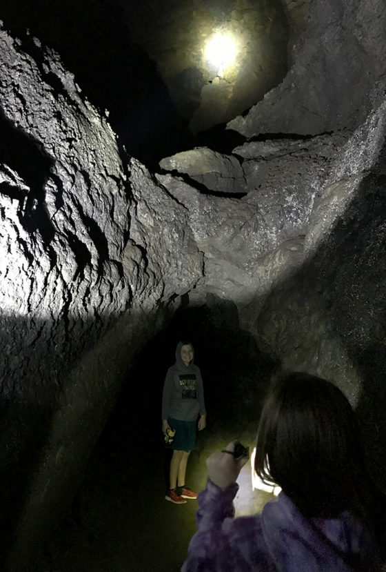 Carter Bourn Standing Under a Lava Tube Inside Another Lava Tube