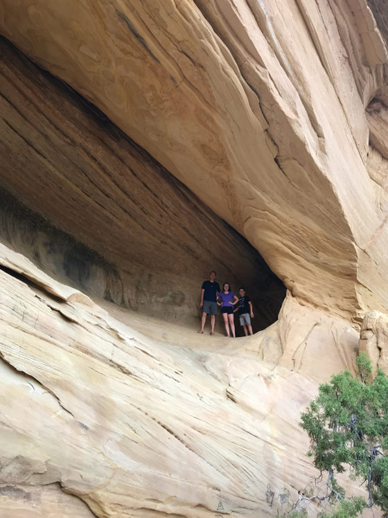 Brian, Natalie, and Carter Bourn in the cave behind Moonshine Arch