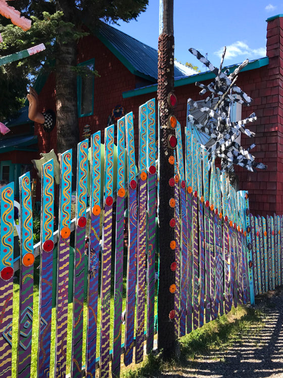 Colorful Painted Fence Decorated With Reflectors