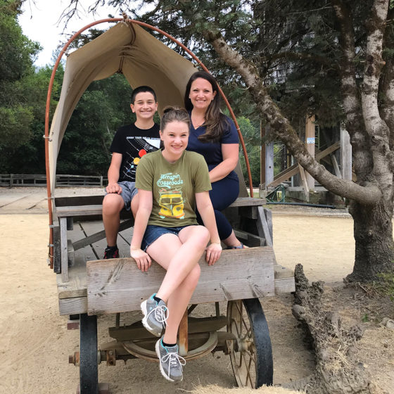 Jennifer, Natalie, and Carter Bourn Sitting in a Covered Wagon at Roaring Camp
