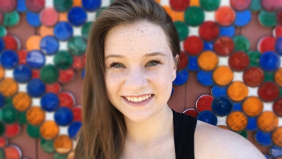 Natalie Bourn In Front Of A Wall Covered In Reflectors
