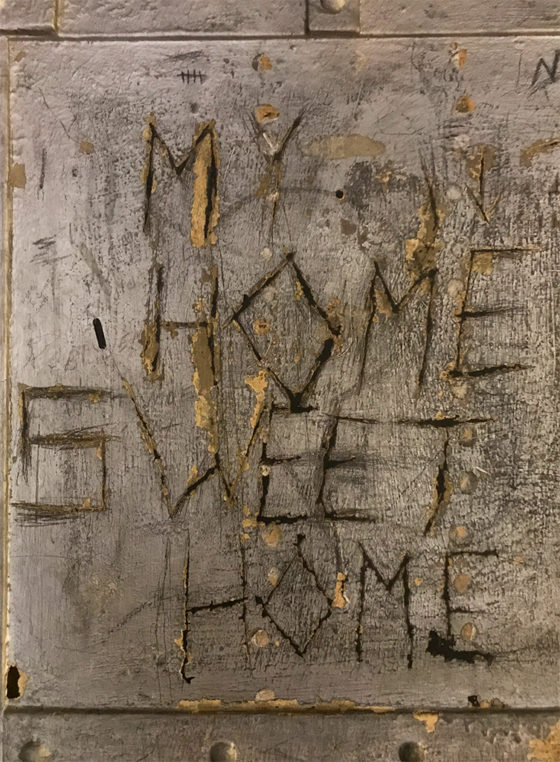 Message SCratched Into A Jail Cell Wall