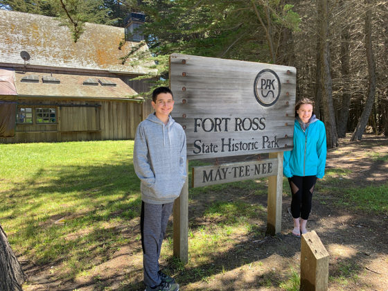Carter and Natalie Standing By The Fort Ross State Historic Park Sign