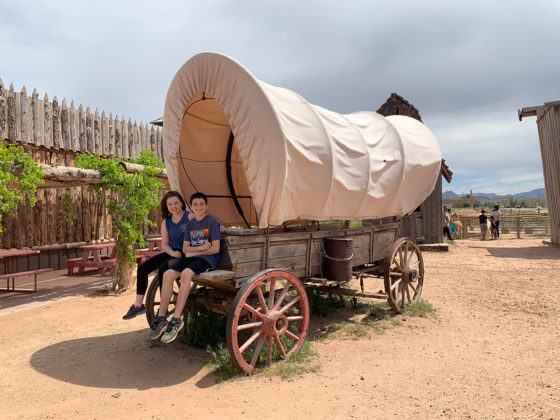 Natalie and Carter Sitting in a Covered Wagon