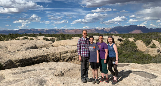 Bourn Family Standing On Top Of A Rock Plateau
